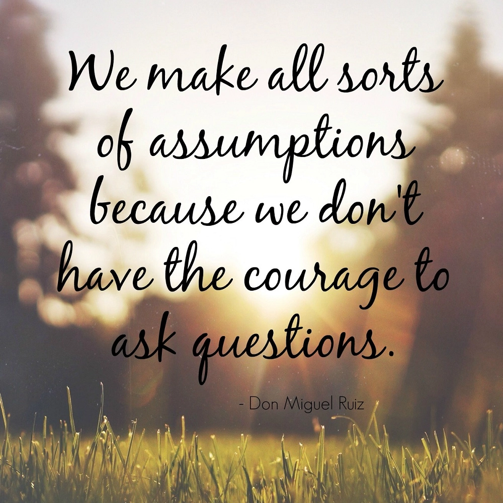 Inspirational quote that reads, “We make a lot of assumptions because we don’t have the courage to ask questions,” displayed over a blurred background of warm sunlight