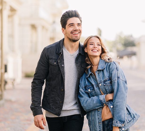 Happy couple walking together outdoors on a sunny day